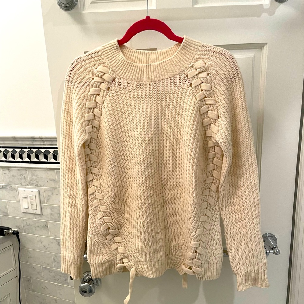 Beautiful cream knit sweater with lacing along sides. IKKS from Paris